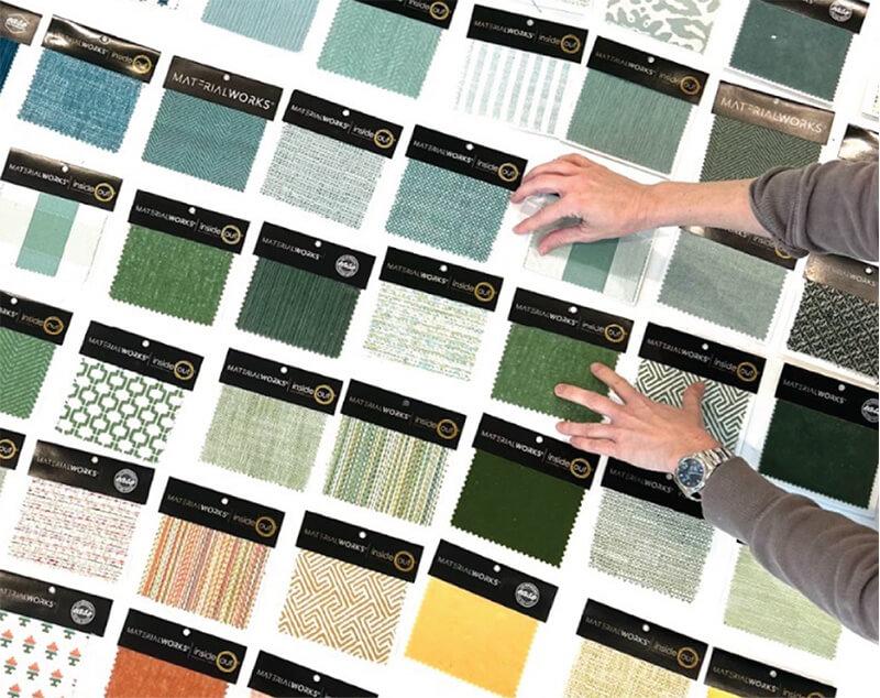 fabric samples of all colors carefully laid out on a table 